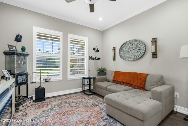 living area featuring baseboards, a ceiling fan, ornamental molding, wood finished floors, and recessed lighting