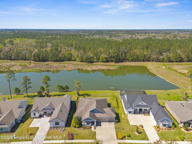 aerial view featuring a water view, a forest view, and a residential view