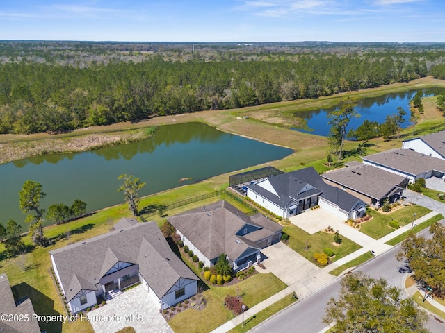 drone / aerial view featuring a water view and a view of trees