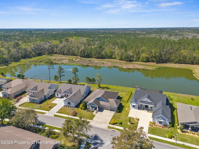 bird's eye view featuring a forest view, a water view, and a residential view