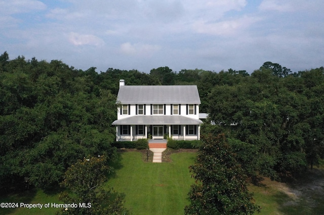 drone / aerial view featuring a forest view