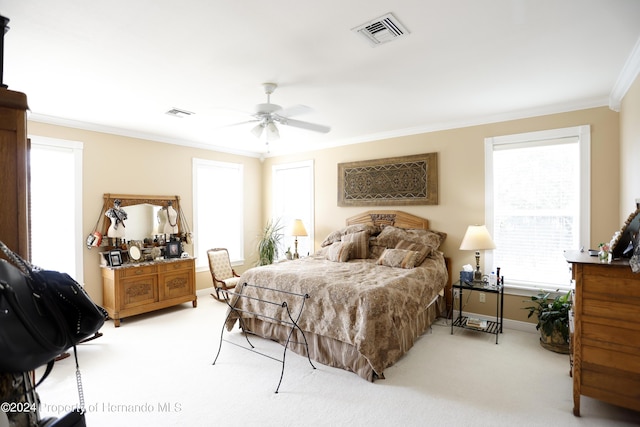 bedroom featuring ornamental molding, light colored carpet, and visible vents