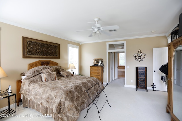 bedroom featuring ornamental molding, light colored carpet, visible vents, and multiple windows