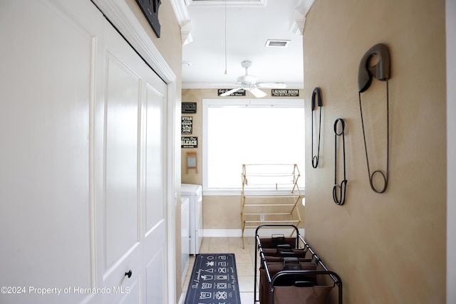 corridor with attic access, baseboards, visible vents, tile patterned floors, and washer and dryer