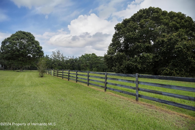 view of yard featuring a rural view and fence