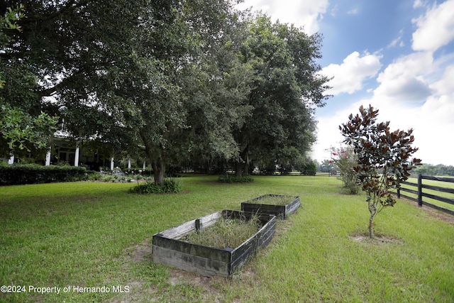 view of yard featuring a vegetable garden and fence