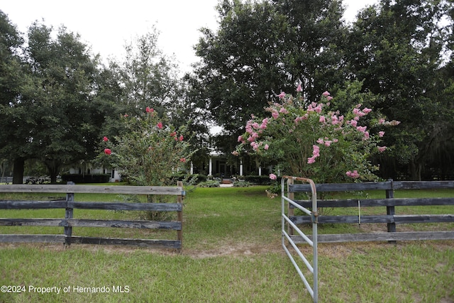 view of gate featuring a yard and fence