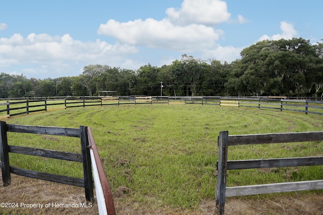 view of yard featuring a rural view and an enclosed area