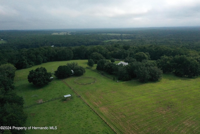 drone / aerial view with a forest view and a rural view