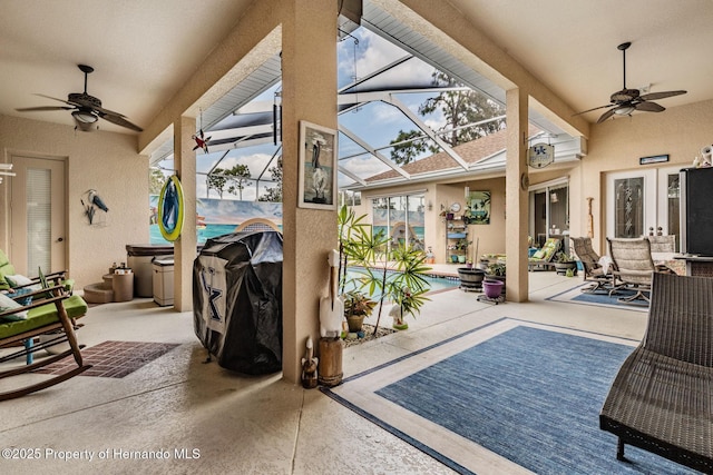 view of patio / terrace featuring glass enclosure, ceiling fan, an outdoor pool, and grilling area