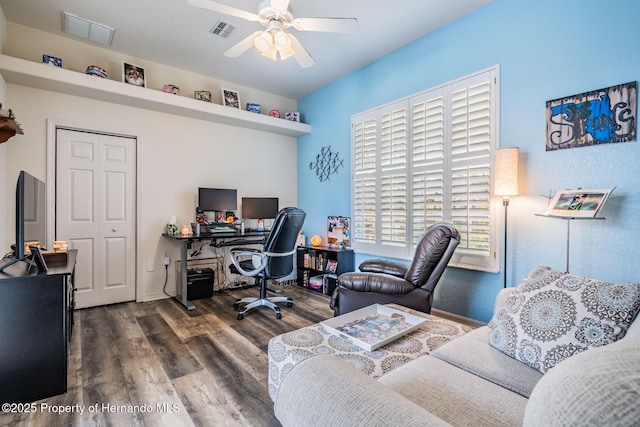 office with a ceiling fan, visible vents, and wood finished floors