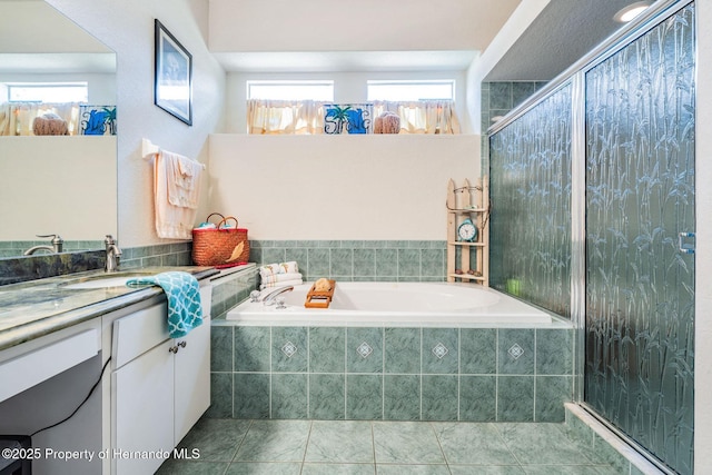 bathroom featuring a bath, tile patterned floors, tiled shower, and vanity