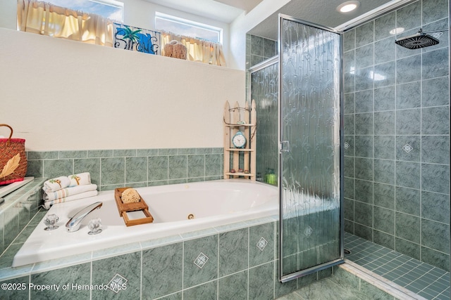 full bathroom with a stall shower and a tub with jets