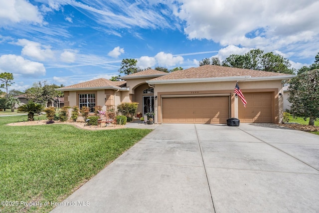 view of front of property with driveway, a garage, a front lawn, and stucco siding