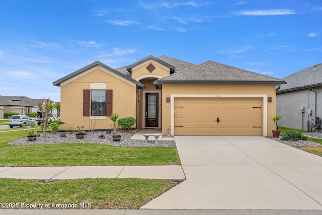 single story home with a front lawn, concrete driveway, an attached garage, and stucco siding