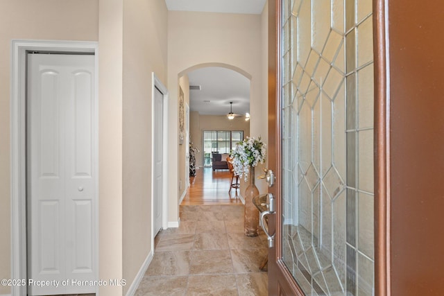 interior space featuring arched walkways and baseboards