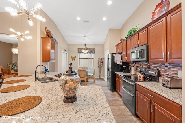 kitchen with stainless steel appliances, visible vents, a sink, and an inviting chandelier