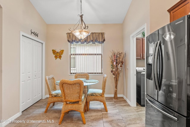 dining area with washer / clothes dryer and baseboards