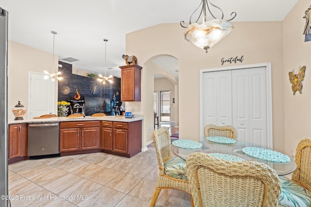 kitchen with arched walkways, light stone counters, hanging light fixtures, stainless steel dishwasher, and brown cabinets