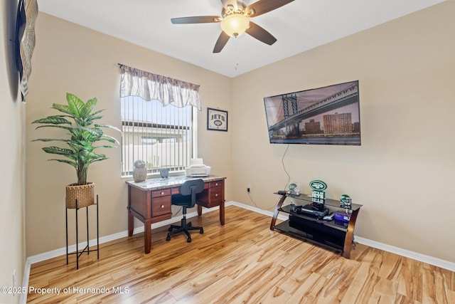 office area featuring wood finished floors, a ceiling fan, and baseboards