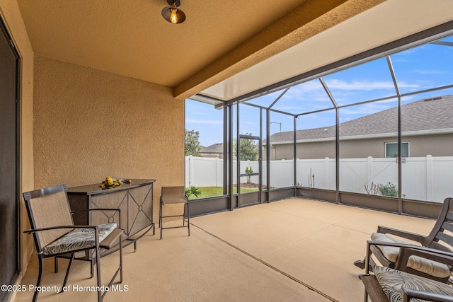 view of patio featuring a lanai and fence