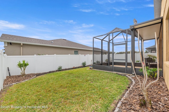 view of yard featuring a fenced backyard and a lanai