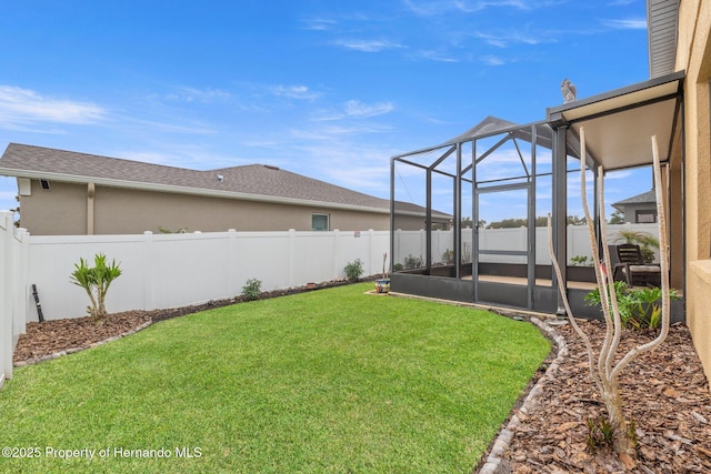 view of yard featuring glass enclosure and a fenced backyard