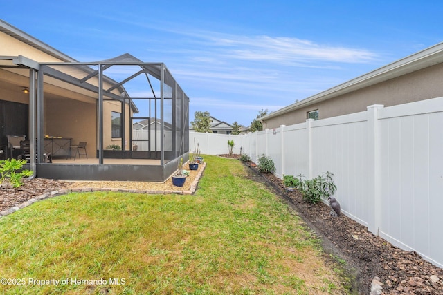 view of yard featuring a lanai and a fenced backyard