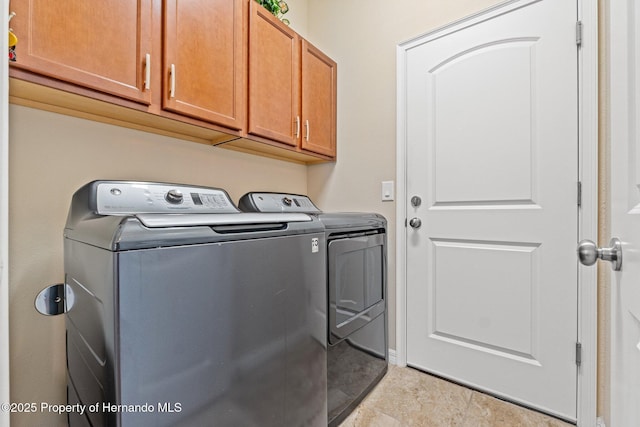 laundry area featuring washing machine and dryer and cabinet space