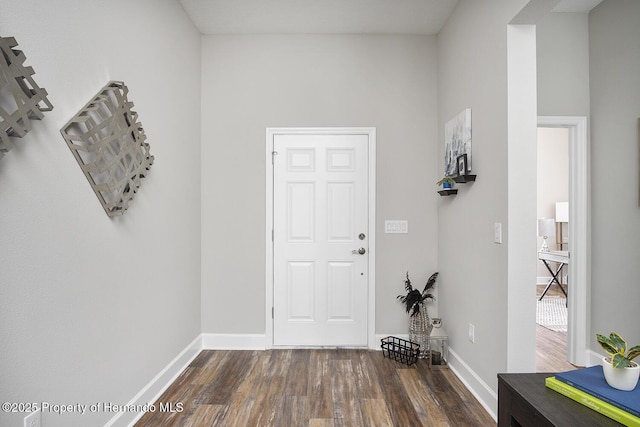 entrance foyer featuring dark wood-style floors and baseboards