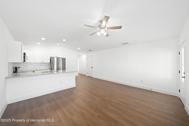 unfurnished living room with baseboards, lofted ceiling, ceiling fan, dark wood-style flooring, and recessed lighting