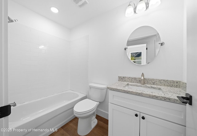 bathroom with bathtub / shower combination, toilet, wood finished floors, vanity, and visible vents