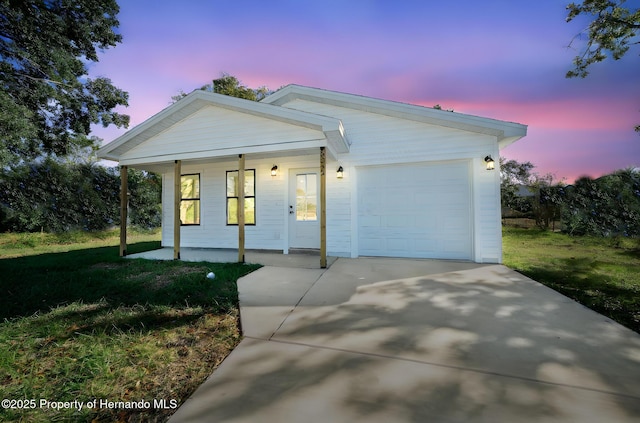 view of front of house featuring an attached garage, driveway, and a porch