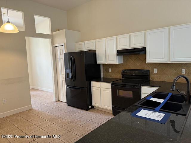 5165 Greystone Dr, Spring Hill, FL 34609 - kitchen with a sink, white cabinets, black appliances, and under cabinet range hood
