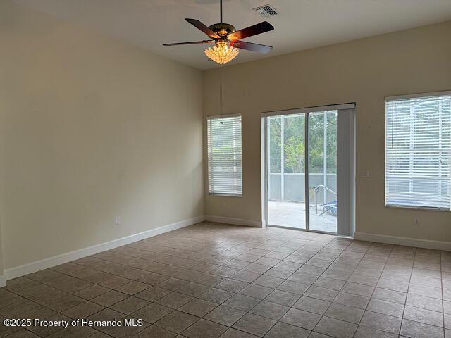 5165 Greystone Dr, Spring Hill, FL 34609 - tiled spare room with visible vents, baseboards, and ceiling fan