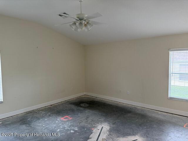5165 Greystone Dr, Spring Hill, FL 34609 - unfurnished room featuring concrete floors, baseboards, and a ceiling fan