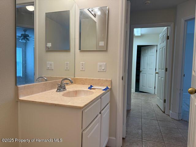 5165 Greystone Dr, Spring Hill, FL 34609 - bathroom with tile patterned floors, a ceiling fan, and vanity