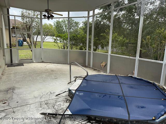 5165 Greystone Dr, Spring Hill, FL 34609 - unfurnished sunroom with a ceiling fan