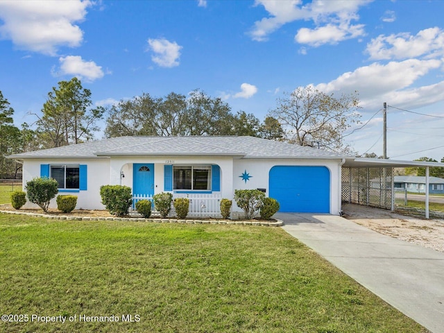 ranch-style house with driveway, a front yard, a carport, and stucco siding