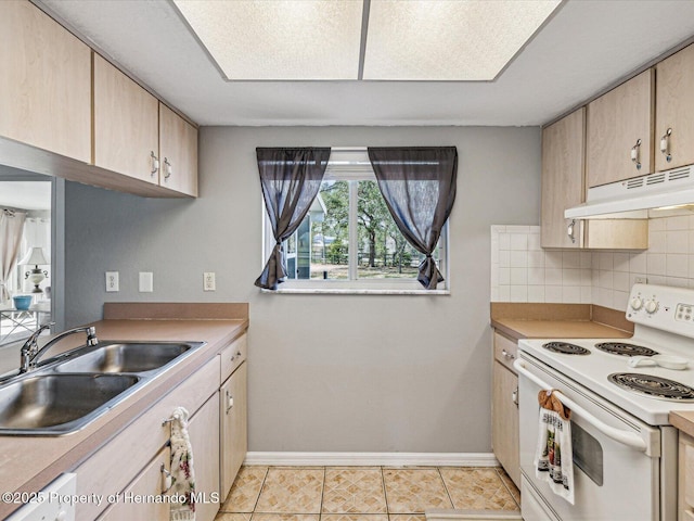 kitchen with white electric range oven, backsplash, light brown cabinets, a sink, and under cabinet range hood