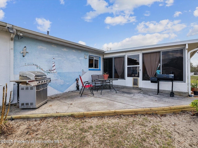 back of property featuring a patio area and stucco siding