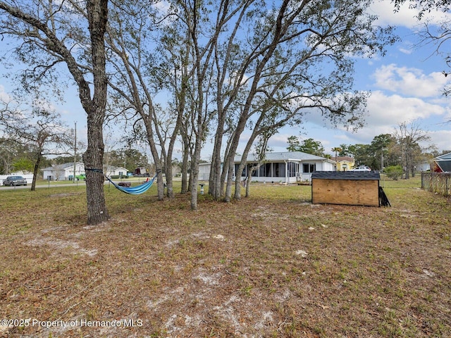 view of yard with an outbuilding and fence