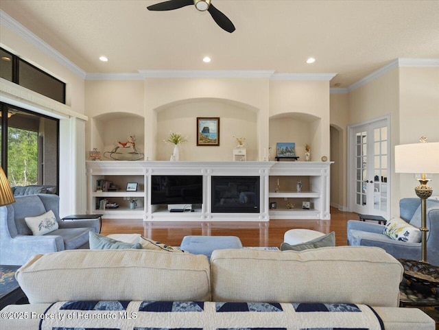 living area with ornamental molding, french doors, wood finished floors, and recessed lighting