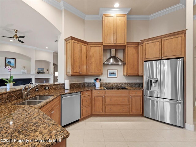 kitchen with wall chimney exhaust hood, ornamental molding, stainless steel appliances, and a sink