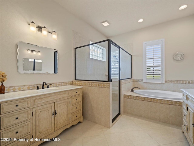 full bathroom with a garden tub, tile patterned flooring, a shower stall, and vanity