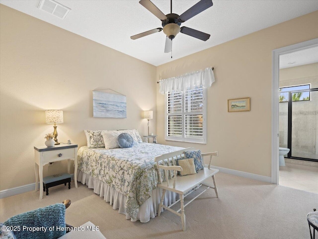 bedroom featuring light carpet, baseboards, visible vents, and connected bathroom