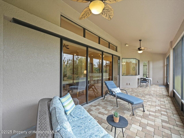 sunroom / solarium with ceiling fan