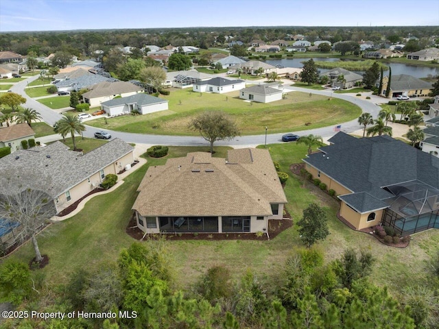 drone / aerial view with a water view and a residential view