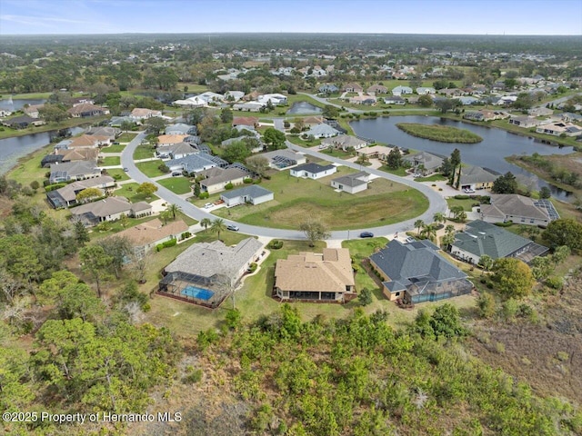 drone / aerial view featuring a residential view and a water view