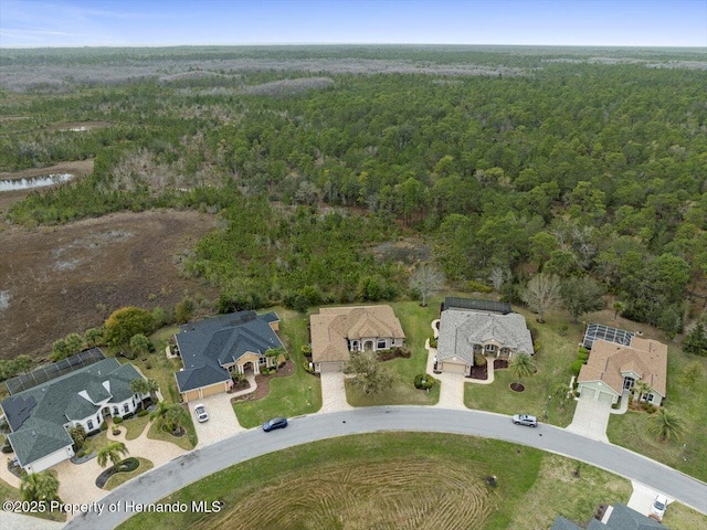 birds eye view of property with a residential view and a wooded view